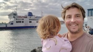 Jan Willem with his daughter, Wightlink ferry behind them at Portsmouth
